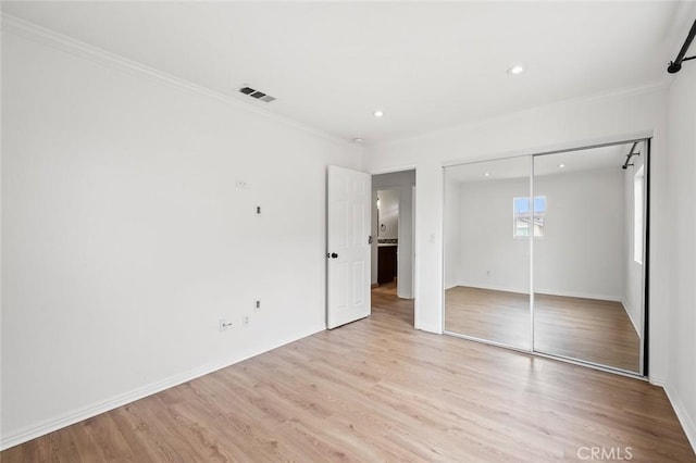 943 Solem St, Azusa, CA 91702 - unfurnished bedroom with light wood-style flooring, recessed lighting, a closet, baseboards, and crown molding