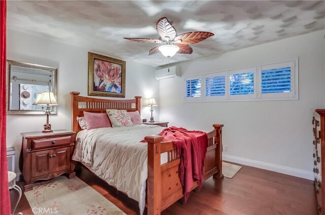 1717 Cumbre Dr, San Pedro, CA 90732 - bedroom with a wall unit AC, light wood-type flooring, baseboards, and a ceiling fan