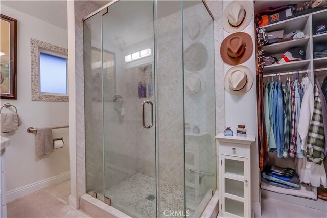 1717 Cumbre Dr, San Pedro, CA 90732 - bathroom featuring a shower stall, baseboards, and a spacious closet
