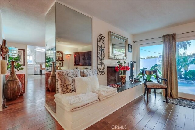 1717 Cumbre Dr, San Pedro, CA 90732 - living room featuring wood finished floors and a fireplace with raised hearth