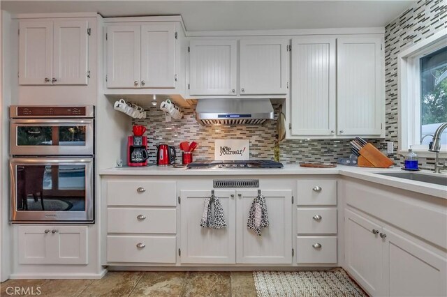 1717 Cumbre Dr, San Pedro, CA 90732 - kitchen with stainless steel appliances, a sink, light countertops, and range hood