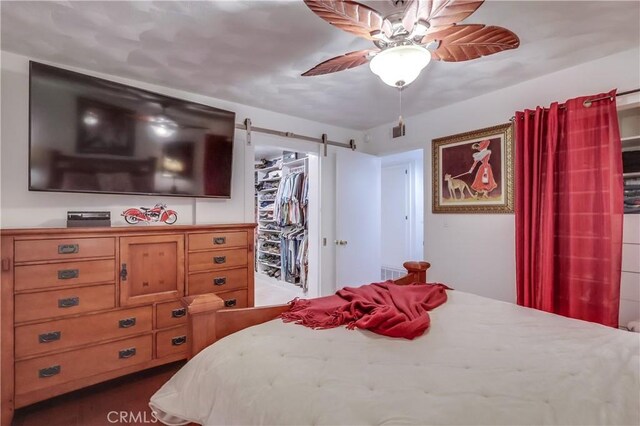 1717 Cumbre Dr, San Pedro, CA 90732 - bedroom with a walk in closet, a barn door, a closet, and ceiling fan