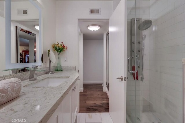 1717 Cumbre Dr, San Pedro, CA 90732 - full bathroom featuring vanity, a stall shower, wood finished floors, and baseboards