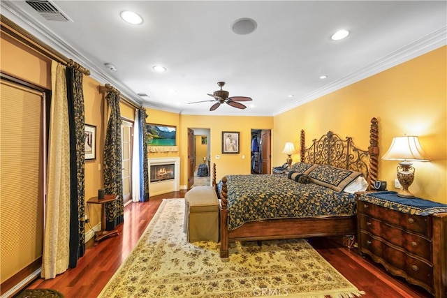 4204 Woodleigh Ln, La Canada Flintridge, CA 91011 - bedroom with ornamental molding, dark wood finished floors, baseboards, recessed lighting, and a warm lit fireplace
