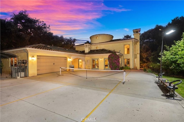 4204 Woodleigh Ln, La Canada Flintridge, CA 91011 - view of front of house with a garage, stucco siding, driveway, and a chimney
