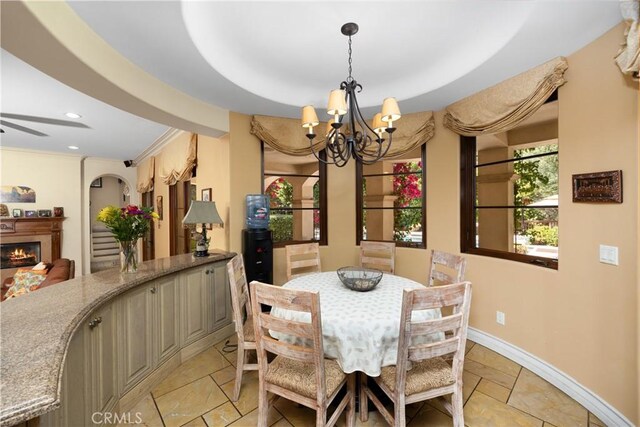 4204 Woodleigh Ln, La Canada Flintridge, CA 91011 - dining area featuring a chandelier, recessed lighting, a lit fireplace, ornamental molding, and baseboards