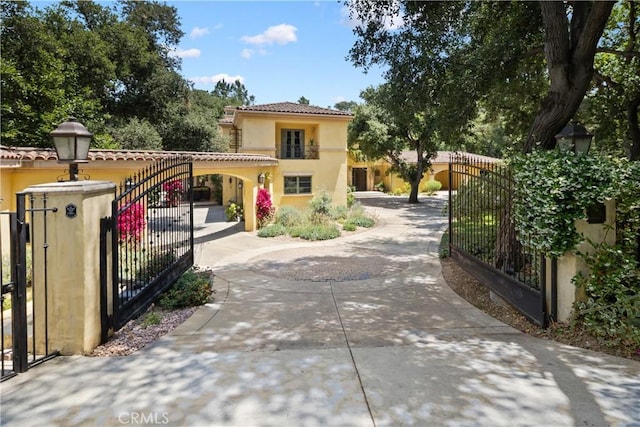 4204 Woodleigh Ln, La Canada Flintridge, CA 91011 - view of front of home with a gate, stucco siding, driveway, and a tile roof