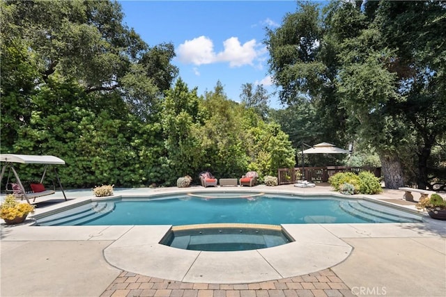 4204 Woodleigh Ln, La Canada Flintridge, CA 91011 - view of swimming pool featuring a deck, view of scattered trees, a pool with connected hot tub, and a patio area