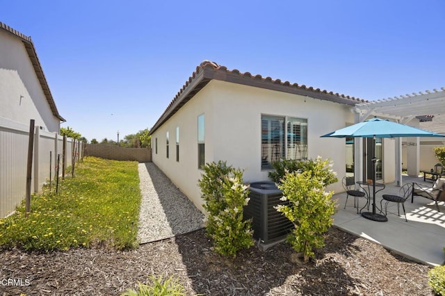 508 Autumn Path Ln, Santa Paula, CA 93060 - view of property exterior with central air condition unit, stucco siding, a fenced backyard, a patio, and a tile roof