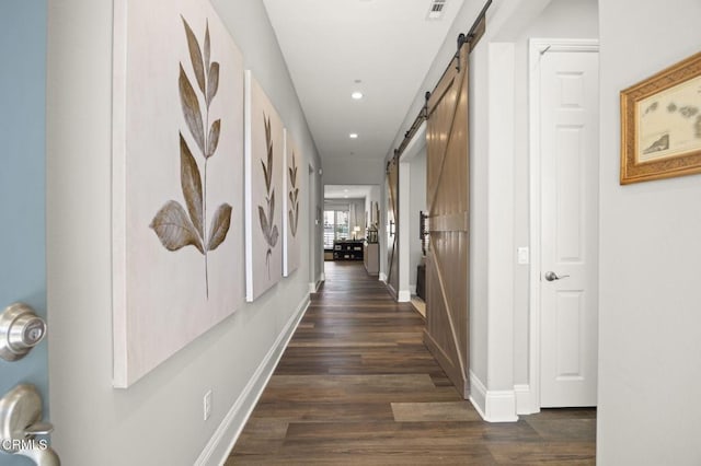 508 Autumn Path Ln, Santa Paula, CA 93060 - hallway with a barn door, dark wood-style flooring, recessed lighting, and baseboards
