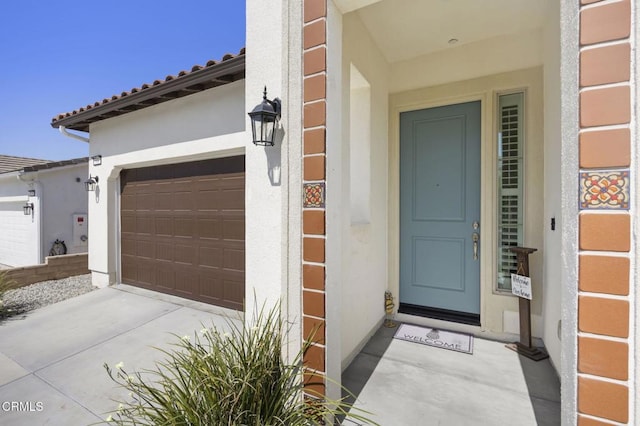 508 Autumn Path Ln, Santa Paula, CA 93060 - property entrance featuring stucco siding, a garage, a tile roof, and driveway