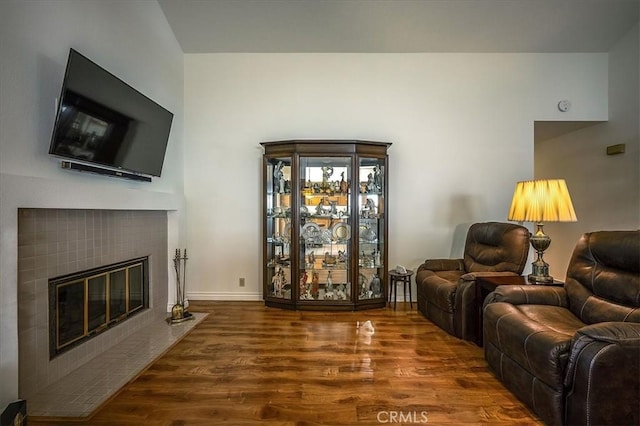 960 Via Serana, Upland, CA 91784 - living room featuring wood finished floors, a tiled fireplace, and baseboards