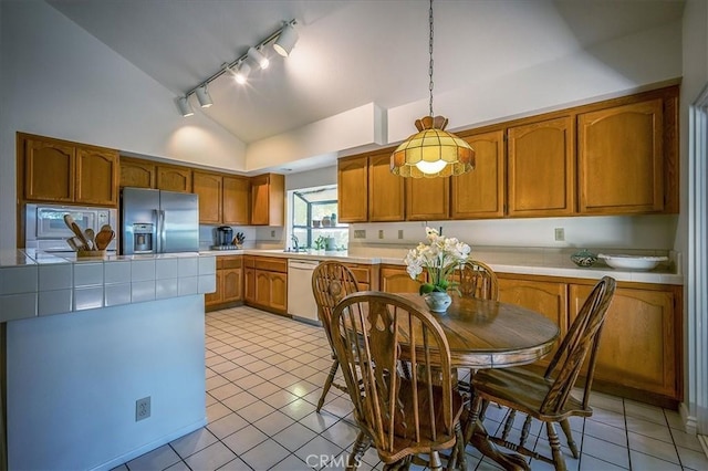 960 Via Serana, Upland, CA 91784 - kitchen with stainless steel refrigerator with ice dispenser, dishwashing machine, vaulted ceiling, track lighting, and light tile patterned flooring