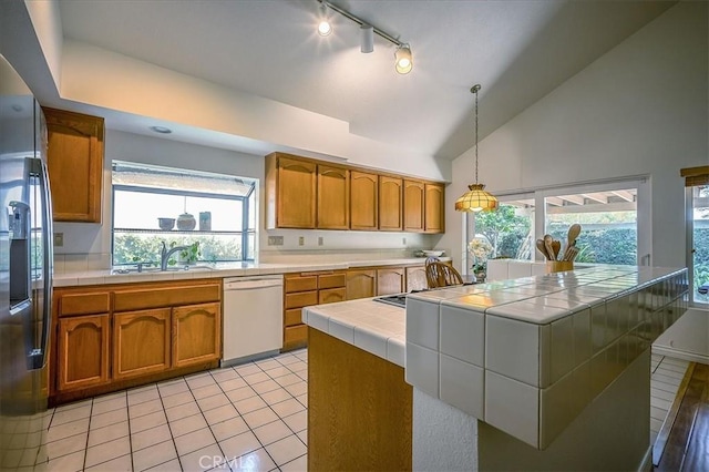 960 Via Serana, Upland, CA 91784 - kitchen with white dishwasher, tile counters, a sink, stainless steel fridge, and brown cabinetry