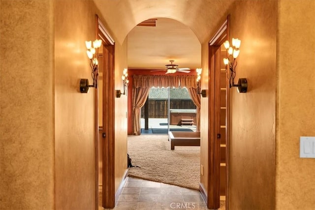 57934 Juarez Dr, Yucca Valley, CA 92284 - hall with arched walkways and carpet floors