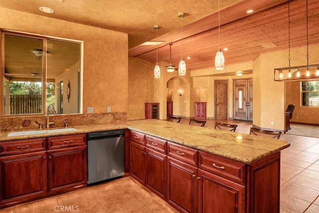 57934 Juarez Dr, Yucca Valley, CA 92284 - kitchen featuring dishwasher, a peninsula, pendant lighting, light stone counters, and light tile patterned flooring