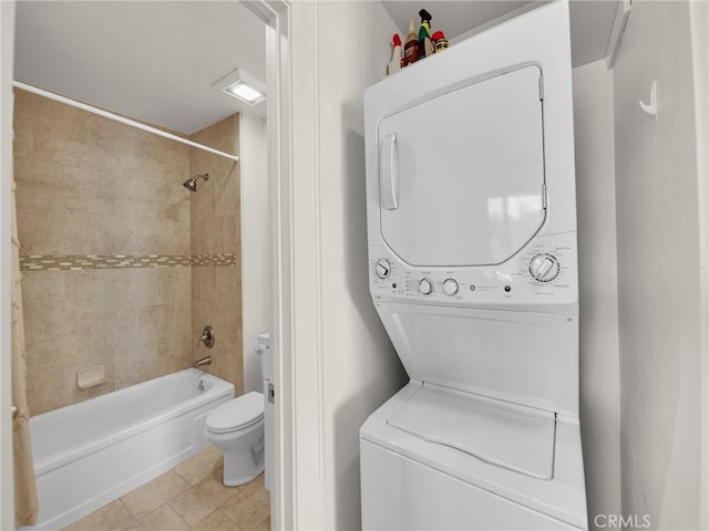 28839 Conejo View Dr, Agoura Hills, CA 91301 - bathroom featuring stacked washer / drying machine, toilet, bathing tub / shower combination, and tile patterned floors