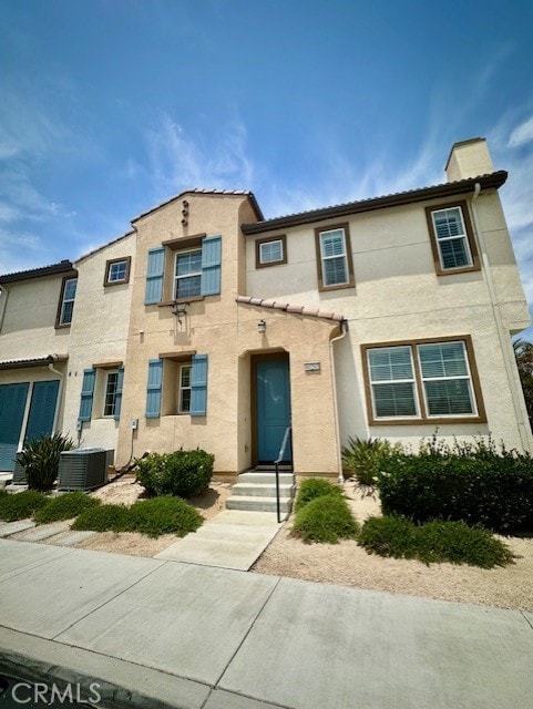 40265 Calle Real, Murrieta, CA 92563 - view of property featuring stucco siding, central AC unit, and a chimney
