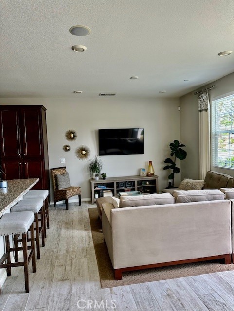 40265 Calle Real, Murrieta, CA 92563 - living area featuring light wood-style floors and a textured ceiling