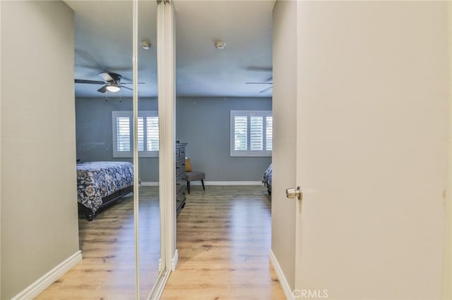 5427 E Pine Ridge Way Unit D, Anaheim, CA 92807 - hallway featuring healthy amount of natural light, light wood-style floors, and baseboards