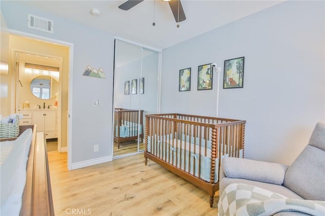 5427 E Pine Ridge Way Unit D, Anaheim, CA 92807 - bedroom with light wood finished floors, a closet, a sink, baseboards, and ceiling fan