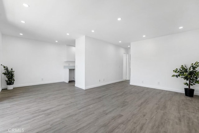 20930 Parthenia St Unit 206, Canoga Park, CA 91304 - unfurnished living room with recessed lighting, wood finished floors, and baseboards