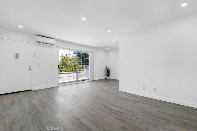 20930 Parthenia St Unit 206, Canoga Park, CA 91304 - unfurnished living room with an AC wall unit, recessed lighting, wood finished floors, and baseboards