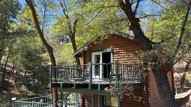 33796 Cedar Pines Ln, Green Valley Lake, CA 92341 - view of property exterior featuring log siding, a deck, and stairway