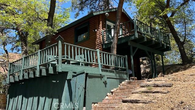 33796 Cedar Pines Ln, Green Valley Lake, CA 92341 - view of home's exterior featuring stairway, a wooden deck, and log siding