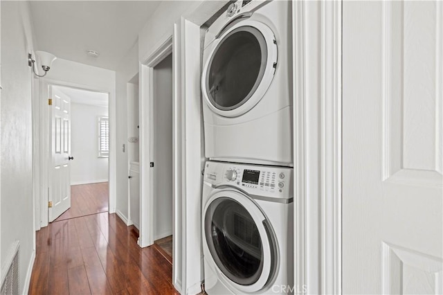 26966 Flo Ln Unit 318, Canyon Country, CA 91351 - washroom featuring stacked washer / dryer and dark wood-style floors