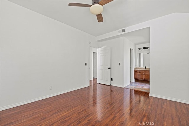 26966 Flo Ln Unit 318, Canyon Country, CA 91351 - unfurnished bedroom with wood finished floors, connected bathroom, and a ceiling fan