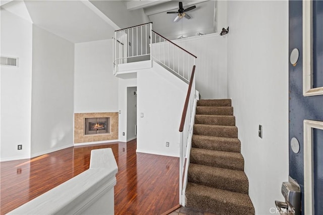 26966 Flo Ln Unit 318, Canyon Country, CA 91351 - stairs with wood finished floors, a ceiling fan, and a fireplace