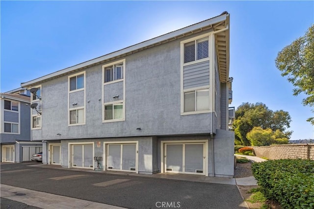 26966 Flo Ln Unit 318, Canyon Country, CA 91351 - rear view of property featuring stucco siding