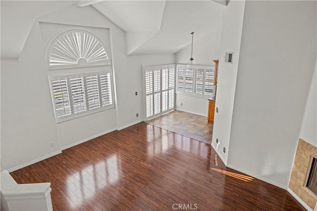 26966 Flo Ln Unit 318, Canyon Country, CA 91351 - unfurnished living room featuring wood finished floors and high vaulted ceiling