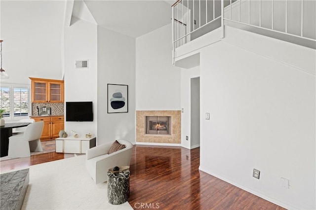 26966 Flo Ln Unit 318, Canyon Country, CA 91351 - living room featuring a high ceiling, wood finished floors, and a tiled fireplace