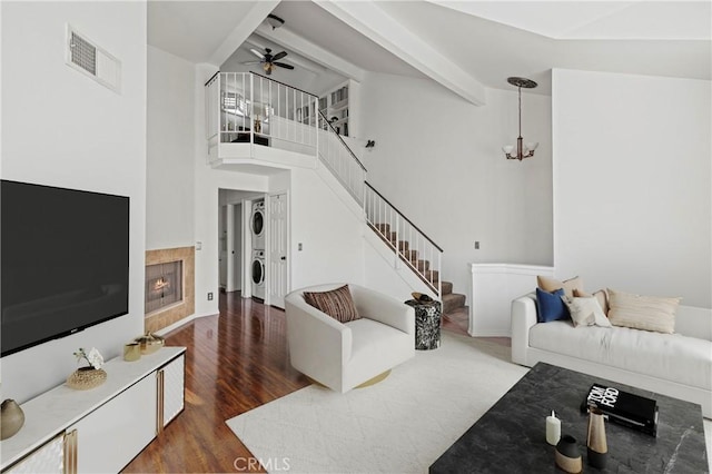 26966 Flo Ln Unit 318, Canyon Country, CA 91351 - living room with stacked washing machine and dryer, stairs, a ceiling fan, wood finished floors, and a fireplace