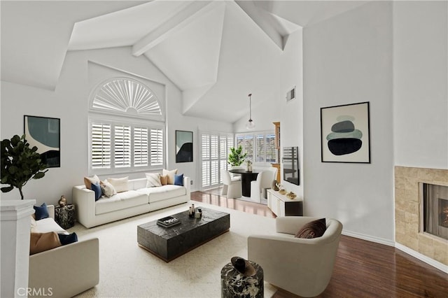26966 Flo Ln Unit 318, Canyon Country, CA 91351 - living area featuring wood finished floors, high vaulted ceiling, a tile fireplace, and beamed ceiling