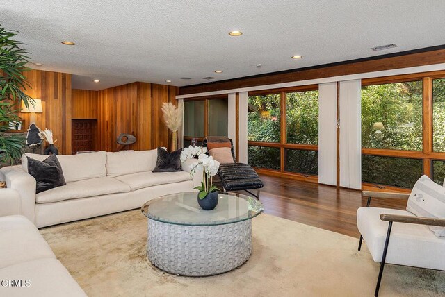 140 Belday Rd, Pasadena, CA 91105 - living area featuring plenty of natural light, a textured ceiling, wood walls, wood finished floors, and recessed lighting