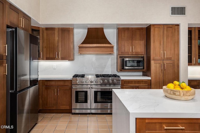 140 Belday Rd, Pasadena, CA 91105 - kitchen with appliances with stainless steel finishes, premium range hood, light tile patterned floors, and brown cabinetry