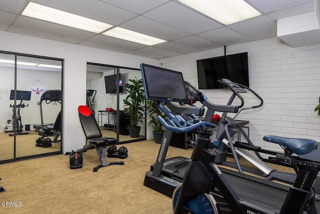 140 Belday Rd, Pasadena, CA 91105 - workout area featuring a paneled ceiling, carpet floors, and brick wall
