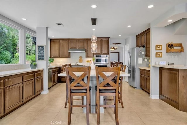 2279 Calle Liseta, San Dimas, CA 91773 - kitchen with appliances with stainless steel finishes, under cabinet range hood, light countertops, recessed lighting, and light tile patterned flooring