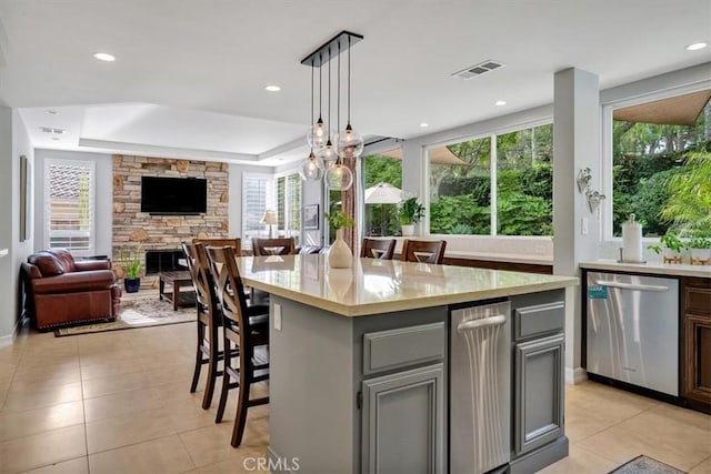 2279 Calle Liseta, San Dimas, CA 91773 - kitchen with stainless steel dishwasher, light tile patterned floors, a kitchen bar, healthy amount of natural light, and recessed lighting