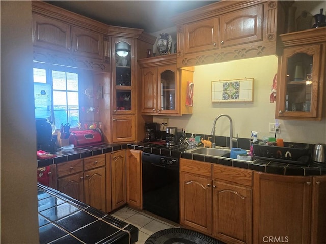 1121 Gladys Ave, Long Beach, CA 90804 - kitchen featuring black dishwasher, a sink, tile countertops, light tile patterned flooring, and brown cabinets