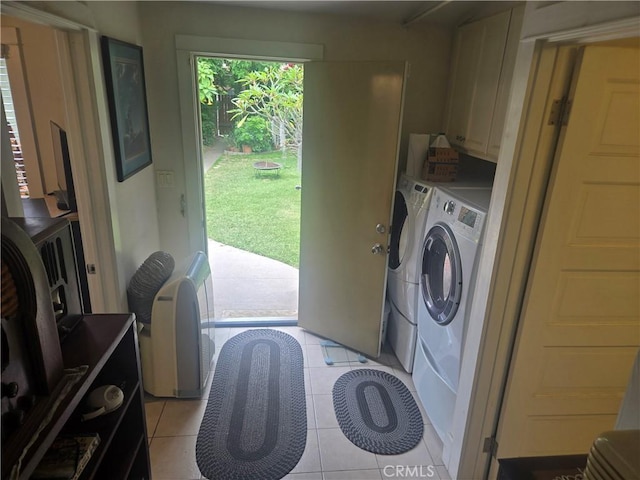 1121 Gladys Ave, Long Beach, CA 90804 - washroom with washing machine and dryer, cabinet space, and light tile patterned floors