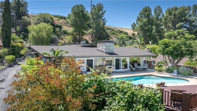 4314 Coronet Dr, Encino, CA 91316 - back of house featuring a patio area and a chimney