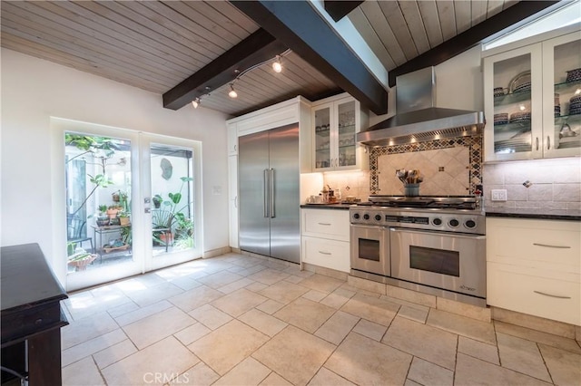 4314 Coronet Dr, Encino, CA 91316 - kitchen with high quality appliances, wall chimney range hood, dark countertops, decorative backsplash, and wooden ceiling with exposed beams