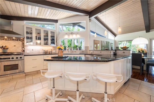 4314 Coronet Dr, Encino, CA 91316 - kitchen featuring stainless steel gas range oven, wall chimney exhaust hood, decorative backsplash, wood ceiling, and white cabinets