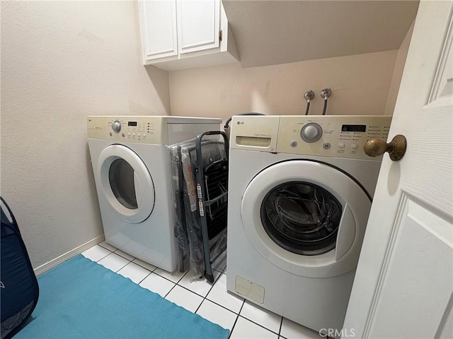 3381 Bandit Cir, Huntington Beach, CA 92649 - washroom featuring washing machine and clothes dryer, cabinet space, and light tile patterned floors