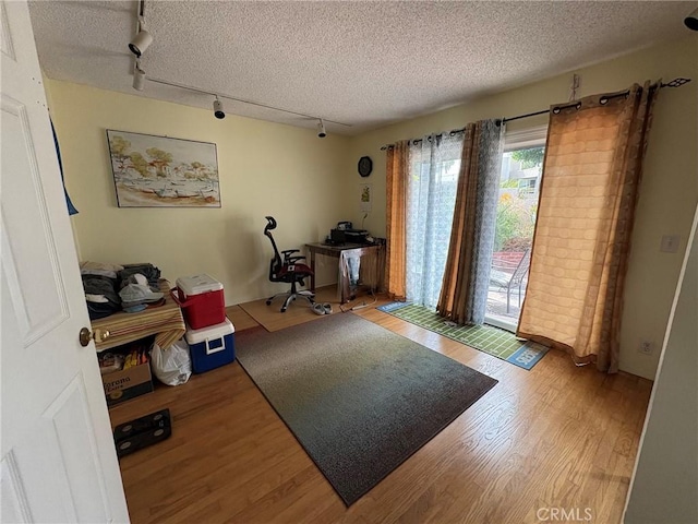 3381 Bandit Cir, Huntington Beach, CA 92649 - office area featuring track lighting, wood finished floors, and a textured ceiling