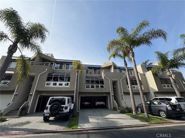 3381 Bandit Cir, Huntington Beach, CA 92649 - view of front facade with a garage, stucco siding, and driveway